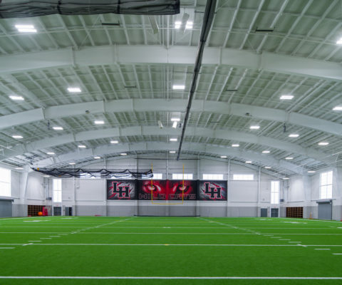 Cadence McShane constructs Lake Highlands High School indoor practice field